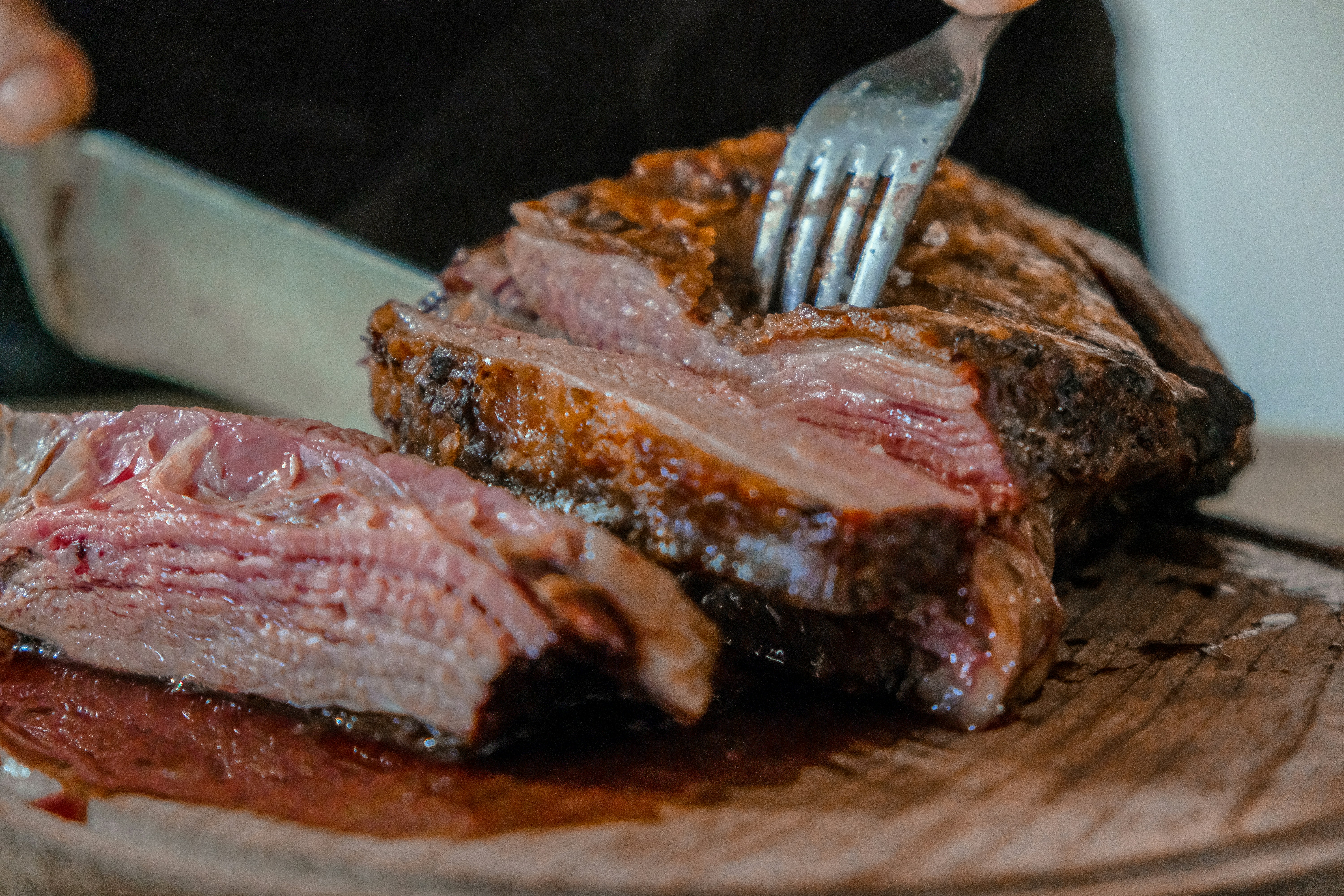 Argentine asado beef being carved at a parrilla in Buenos Aires