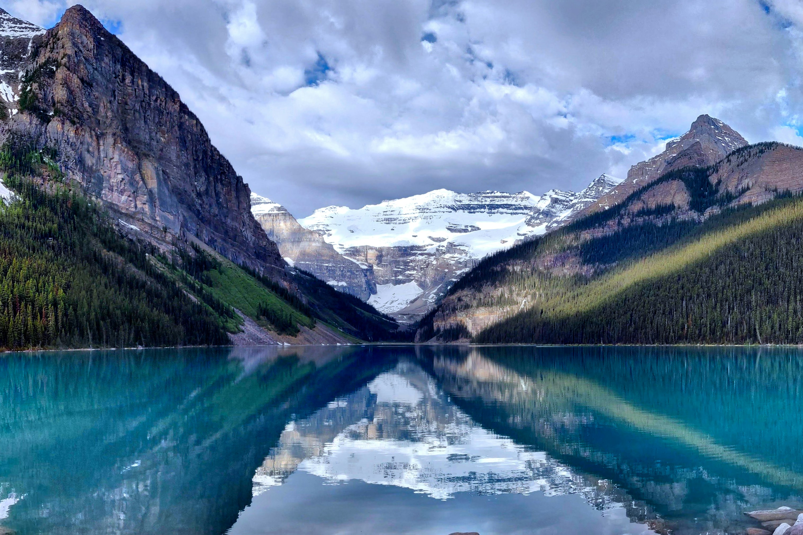 The turquoise water of Lake Louise surrounded by the Canadian Rockies